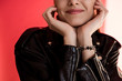 © LIGHTFIELD STUDIOS - cropped view of girl in black leather jacket on red