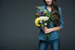 © LIGHTFIELD STUDIOS - cropped view of girl in denim clothes holding bouquet of flowers for international womens day, isolated on grey