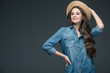 © LIGHTFIELD STUDIOS - pretty cheerful girl in denim shirt and straw hat, isolated on grey