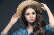 © LIGHTFIELD STUDIOS - beautiful girl in denim shirt and straw hat, isolated on grey