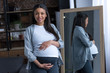 © LIGHTFIELD STUDIOS - african american pregnant woman with big belly standing at mirror