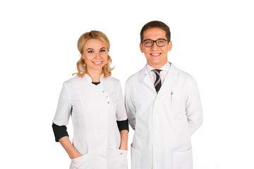 portrait of two happy smiling young medical people, isolated over white background. doctors