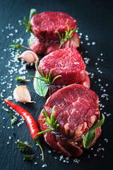 Poster - Raw beef fillet steaks mignon on dark background