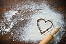 Baking Background With The Rolling Pin, Heart Shape And Flour On The Wooden Table