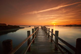 Fototapeta  - old sea pier at sunrise
