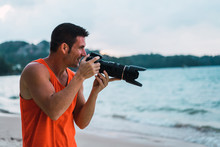 Cheerful Photographer On Beach