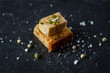 isolated foie gras toast on black plate with sea salt sprinkles