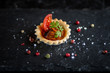 top view of tomato tartelette with fresh tomato and olive slice