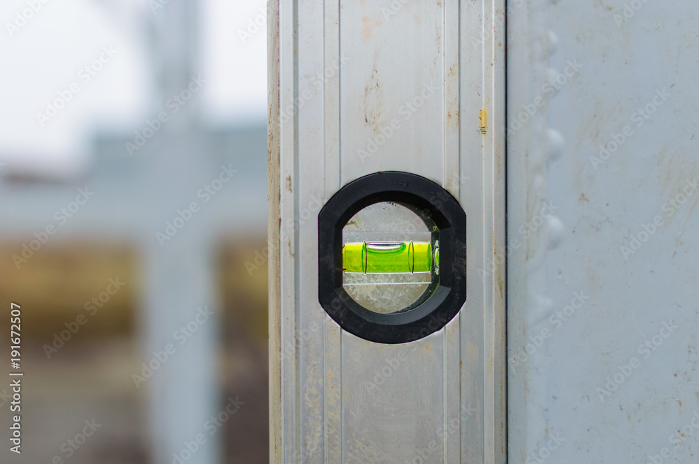 Magnet water bubble level gauge on steel beam at construction site for ...