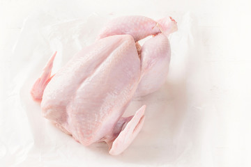 Whole raw chicken.