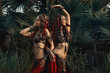 © zolotareva_elina - two beautiful tribal fusion belly dancers in costumes outdoors at sunset