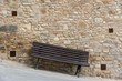 Tilted bench on ancient stone wall