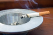 Burning cigarette smoking on an ashtray