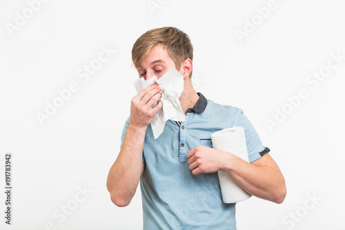 Fotografie, Obraz Young man has a runny nose on white background