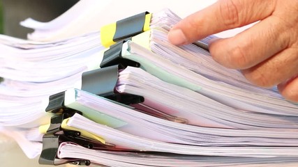 Wall Mural - Businesswoman hands working on Stacks of documents files for finance in office. Business report papers or Piles of unfinished document achieves with black clip paper. Concept of Business Annual Report