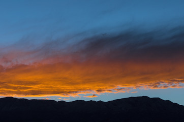 Wall Mural - Blue sky orange clouds landscape background.