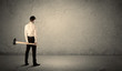 © ra2 studio - Business man standing in front of a grungy wall with a hammer