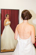bride in shop mirror try nerw white wedding dress