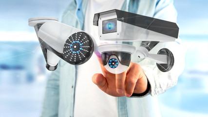Poster - Businessman holding a Security camera system and network connection - 3d rendering