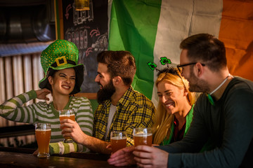 Wall Mural - Group of Friends Celebrating St Patrick's Day in Beer Pub