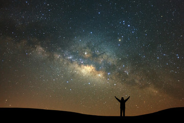 Wall Mural - night landscape with milky way and silhouette of high mountain, starry sky with stars. beautiful uni