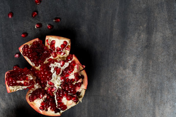 Wall Mural - Fresh pomegranate fruit on dark background copy text.