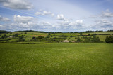 Fototapeta Do pokoju - Summer sunshine view of an idyllic valley in the Cotswold countryside near Painswick, Gloucesteshire, UK.
