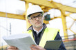 © goodluz - Construction manager on site reading blueprint