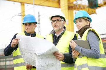 Wall Mural - Construction site manager with young people in training period