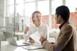 © pressmaster - Confident economist explaining terms of new contract to her colleague at meeting in office