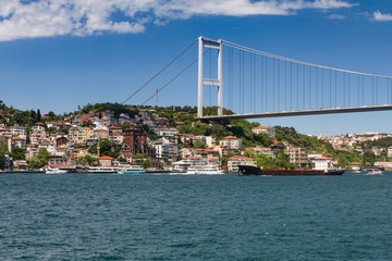 Sticker - View of Fatih Sultan Mehmet Bridge which is localed on Bosphorus strait . Ships passing through bridge connecting Europe and Asia. Sunny day with background of cloudy blue sky. Istanbul. Turkey.