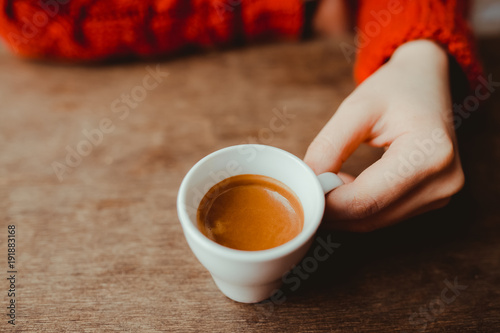 Cuadros en Lienzo Woman is holding in hand hot coffee espresso in white small glass cup
