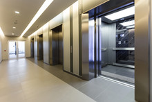 Modern Steel Elevator Cabins In A Business Lobby Or Hotel, Store, Interior, Office,perspective Wide Angle. Three Elevators In Hotel Lobby..