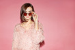 © Sergey Chumakov - stylish female model in pink sweater on pink background