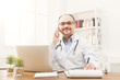 © Prostock-studio - Happy doctor talking on the phone with his patient