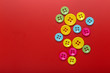© okskaz - colored buttons on a red background colorful texture
