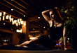 © Dmitry Lobanov - Beautiful sexy fashion brunette woman in expensive interior restaurant relaxing with martini cosmopolitan cocktail