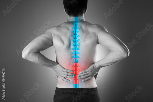 Cuadros en Lienzo Pain in the spine, a man with backache, injury in the lower back