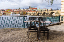 Table Of Closed Cafe On Background Prague Castle And River Vltava, Czech Republic