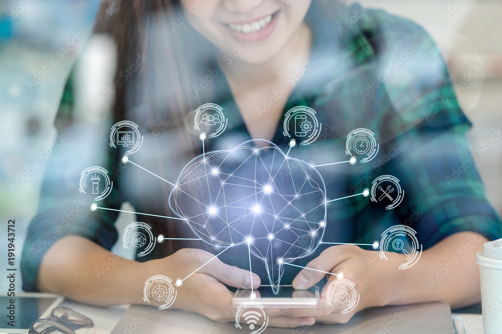 Polygonal brain shape of an artificial intelligence with various icon of smart city Internet of Things Technology over Asian businesswoman hand using the smart mobile phone,AI and business IOT concept - obrazy, fototapety, plakaty 