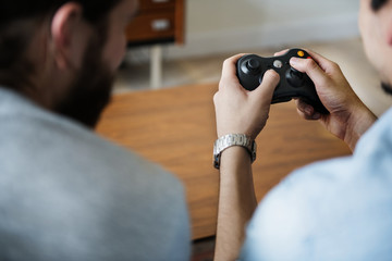 Wall Mural - Rear view of men playing video game