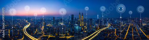 Fotografía Panorama aerial view in the cityscape skyline with smart services and icons, internet of things, networks and augmented reality concept , early morning sunrise scene