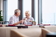 Sweet conversation. Sincere attractive mature couple drinking coffee while chatting and sitting at the restaurant