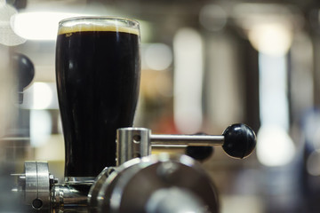 Wall Mural - Pint of stout in a brewery