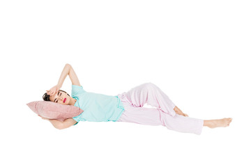 Wall Mural - girl in pajamas lying on pillow with closed eyes isolated on white