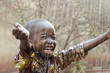 © Riccardo Niels Mayer - Little Native African Boy Standing Outdoors Under the Rain (Water for Africa Symbol)