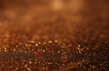 Wall Mural - Gold Festive Christmas background. Elegant abstract background with bokeh defocused lights and stars.