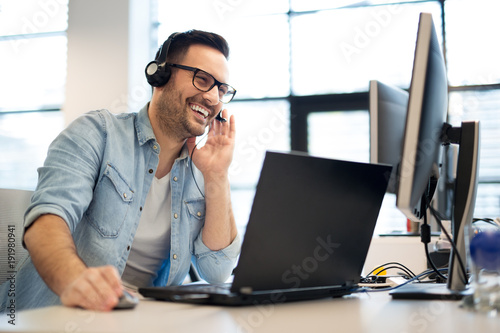 Fotografía Young smiling male call center operator doing his job with a headset