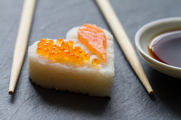 Wall Mural - Sushi heart macro seafood concept with salmon and caviar
