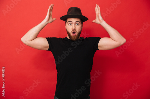 Photo Of Joyous Attractive Man With Beard In Casual Emotionally Throwing Hands Up On In Air Isolated Over Red Background Buy This Stock Photo And Explore Similar Images At Adobe Stock